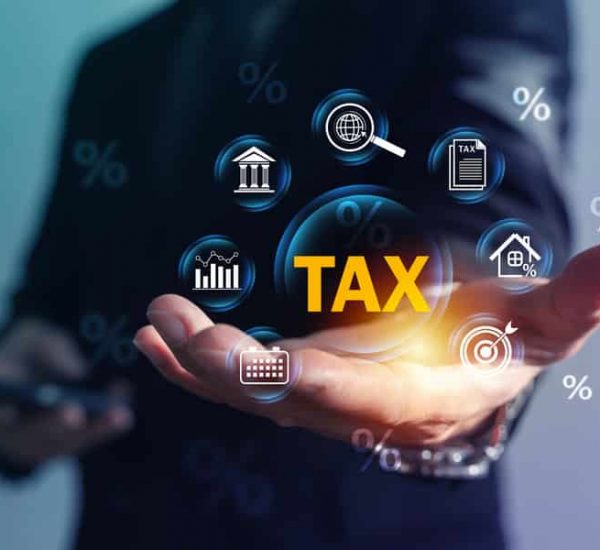Tax Planning and Filing Concept with Businessman Hand Holding TAX and Finance Icons